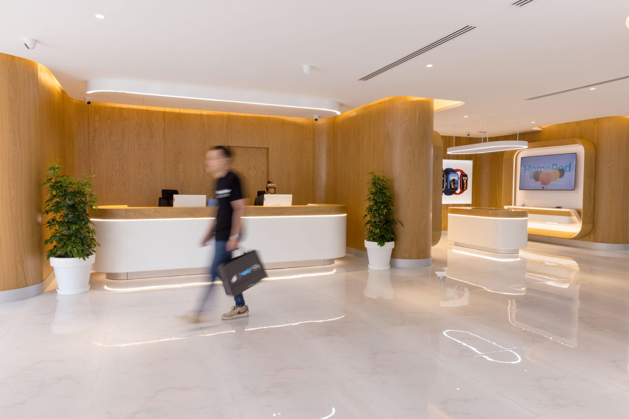 Al Watikon store interior: reception counter with timber wall and planting