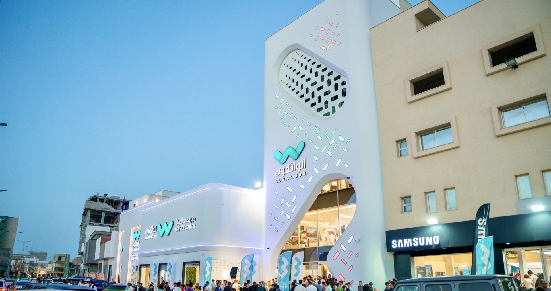 Al Watikon flagship on opening day, crowd gathered under the perforated facade