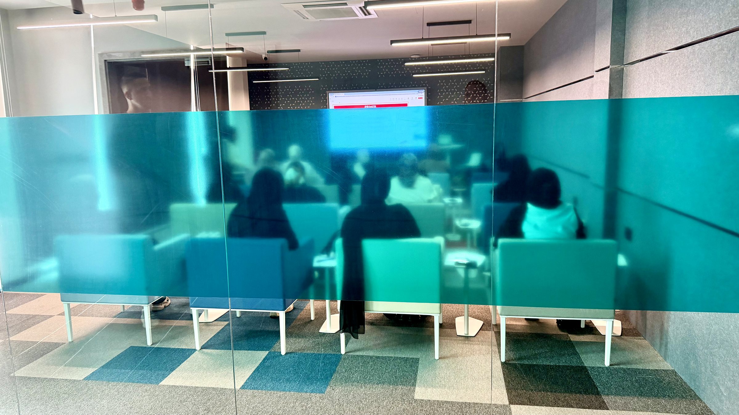 Photo: training room in use, behind teal glass