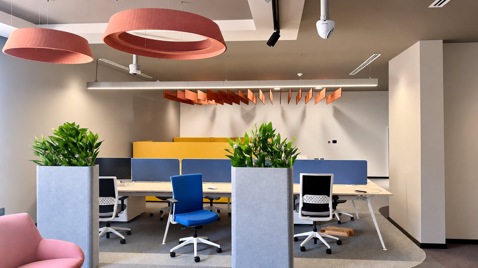 Photo: co-working as built, coral acoustic rings, copper baffles and yellow booths